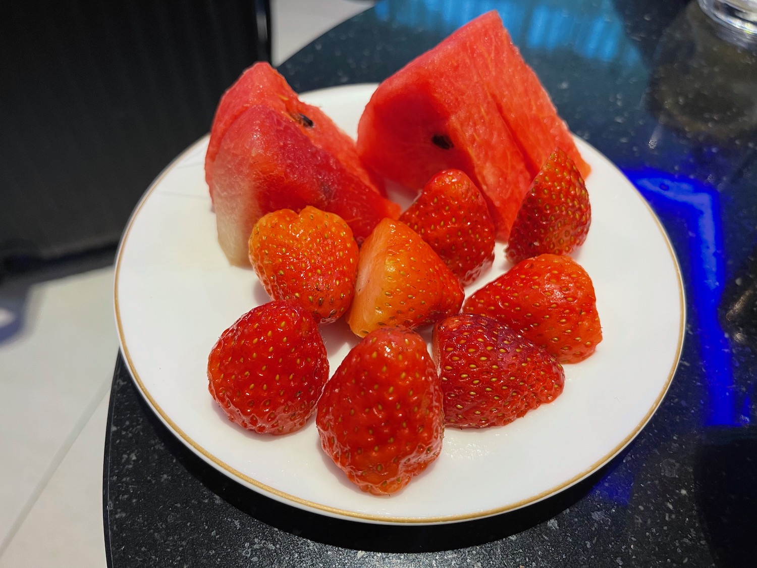 a plate of strawberries and watermelon