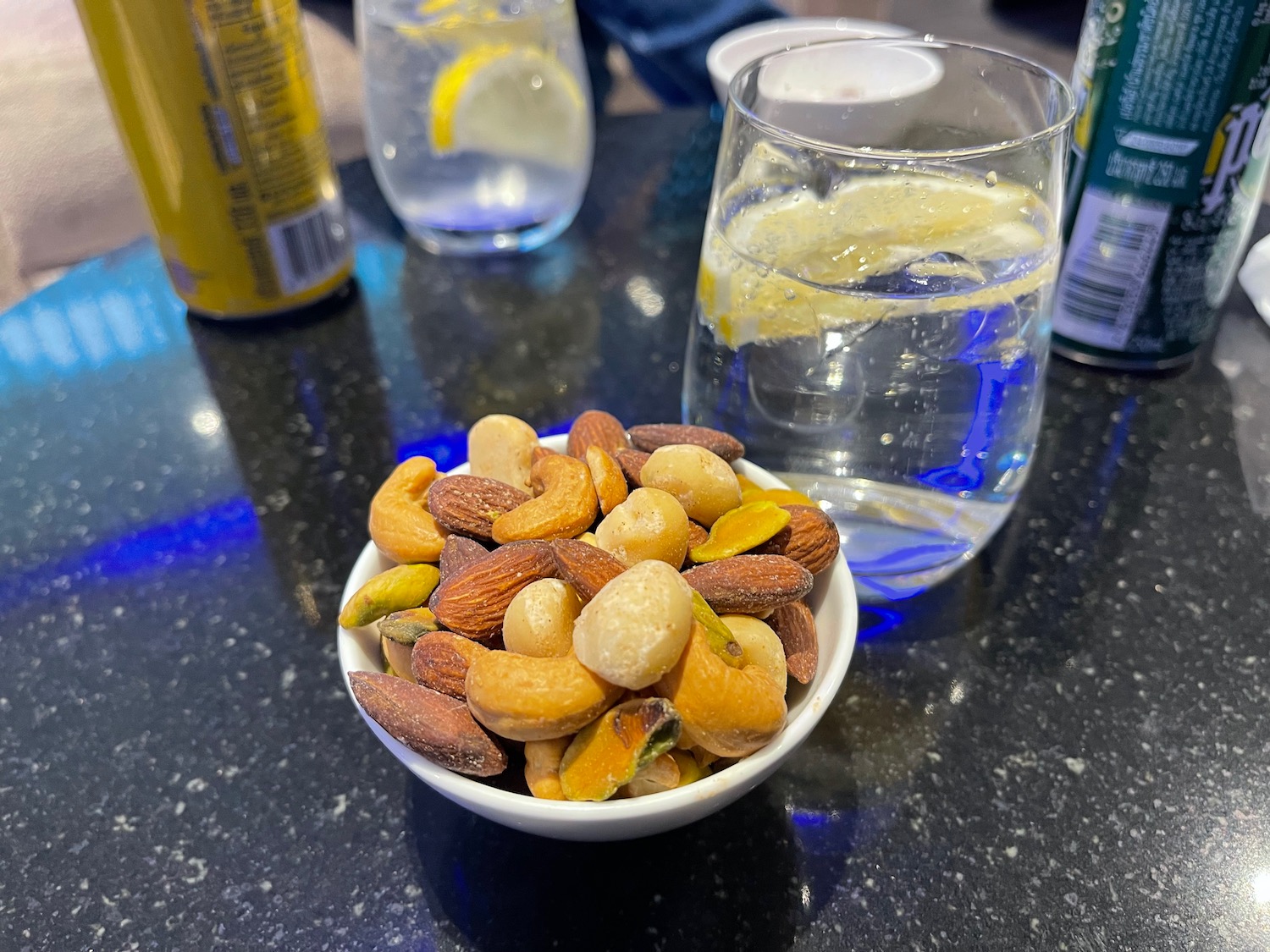 a bowl of nuts and a glass of water