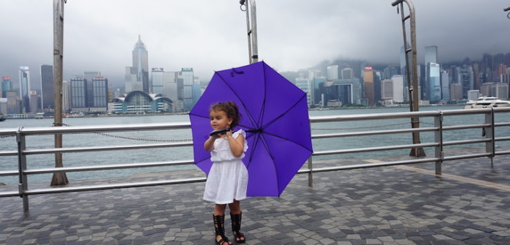 a girl holding a purple umbrella