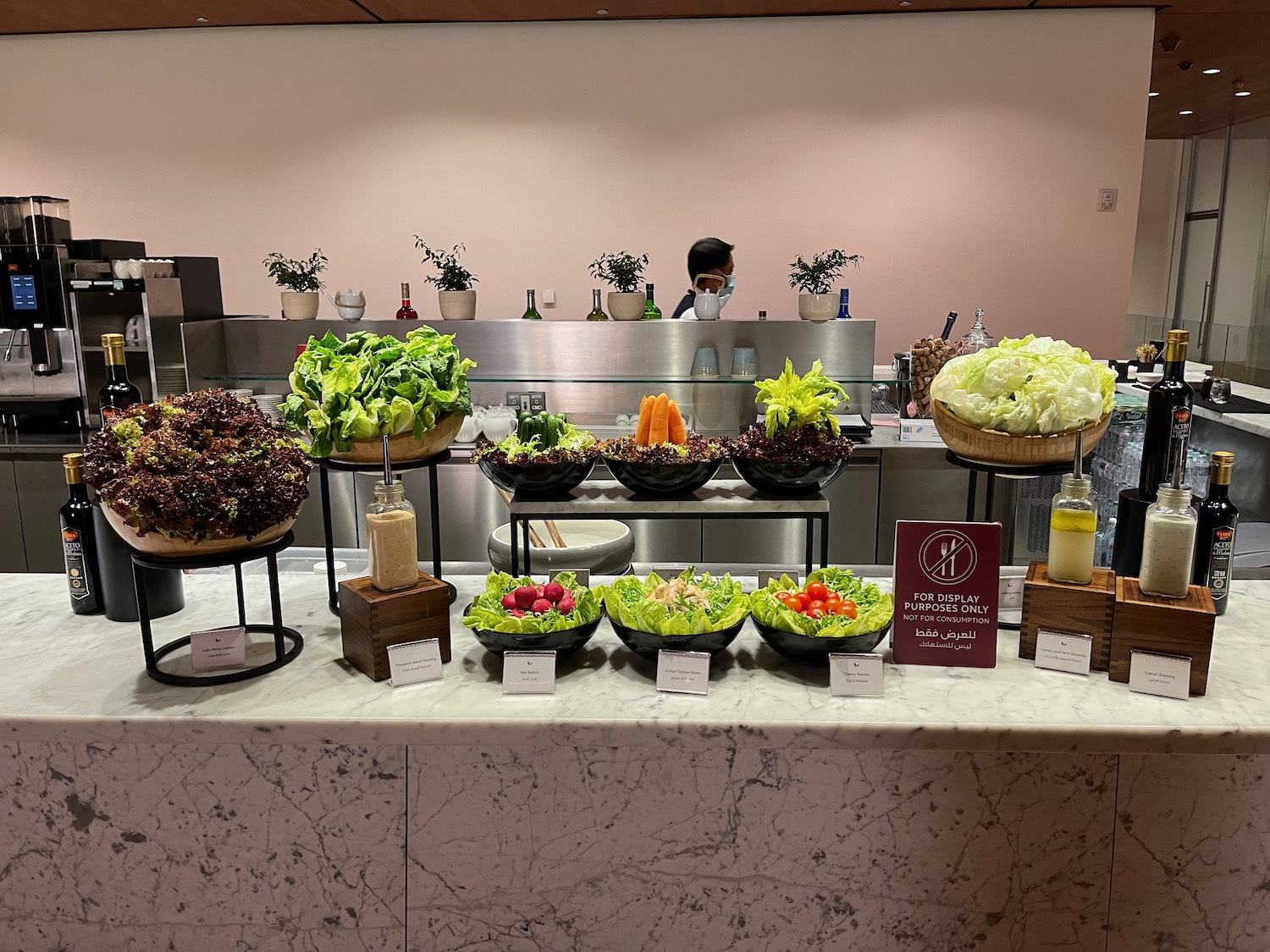 a counter with salads and vegetables on it