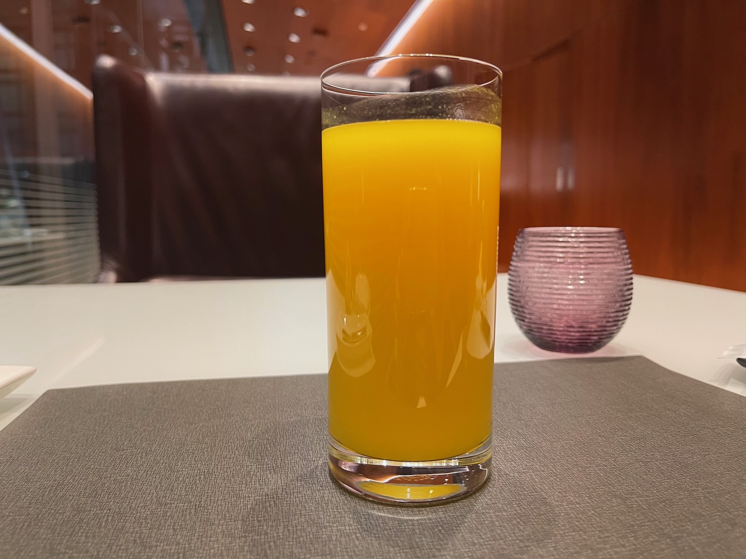 a glass of orange juice on a table