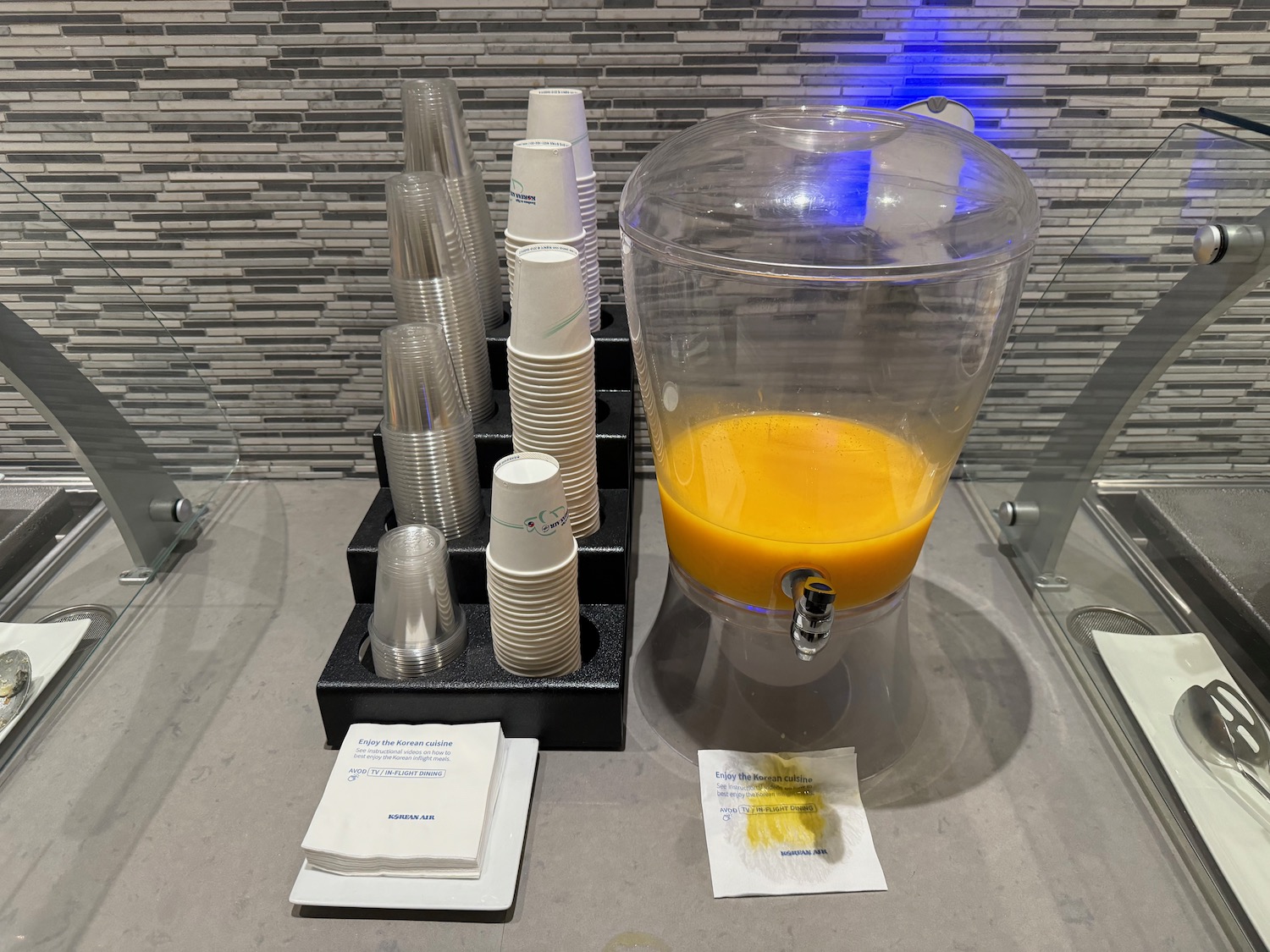 a drink dispenser with a dispenser and several cups