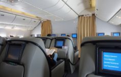 a person sitting in a chair with a book on the back of the seat