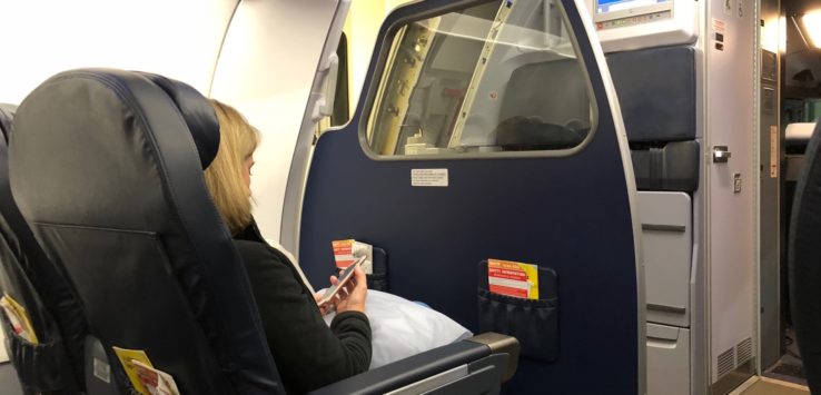 a woman sitting in a chair on an airplane