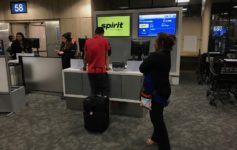 people standing in front of a counter with a group of people