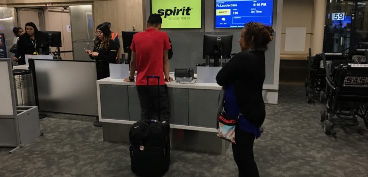 people standing in front of a counter with a group of people
