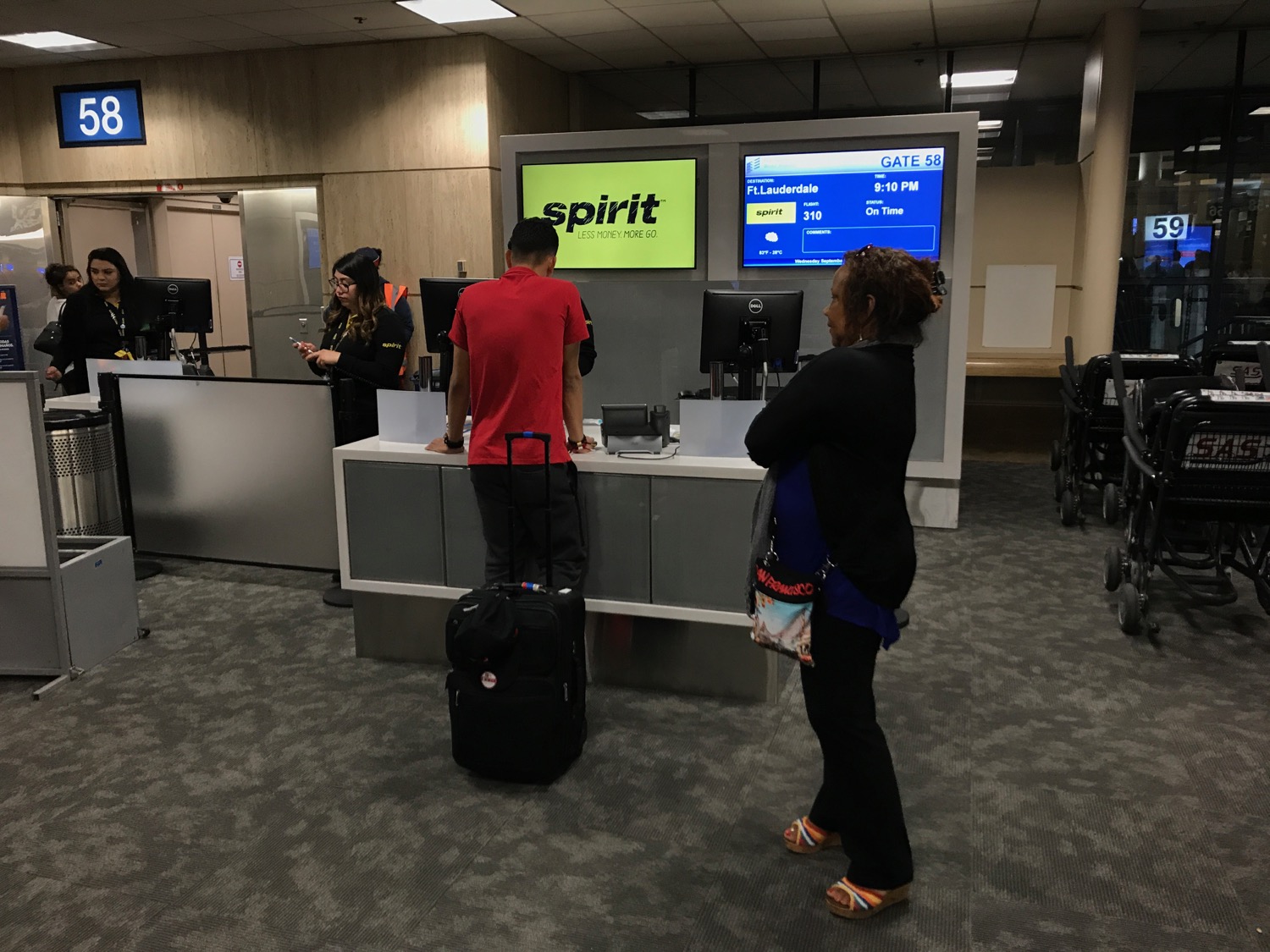people standing in front of a counter with a group of people