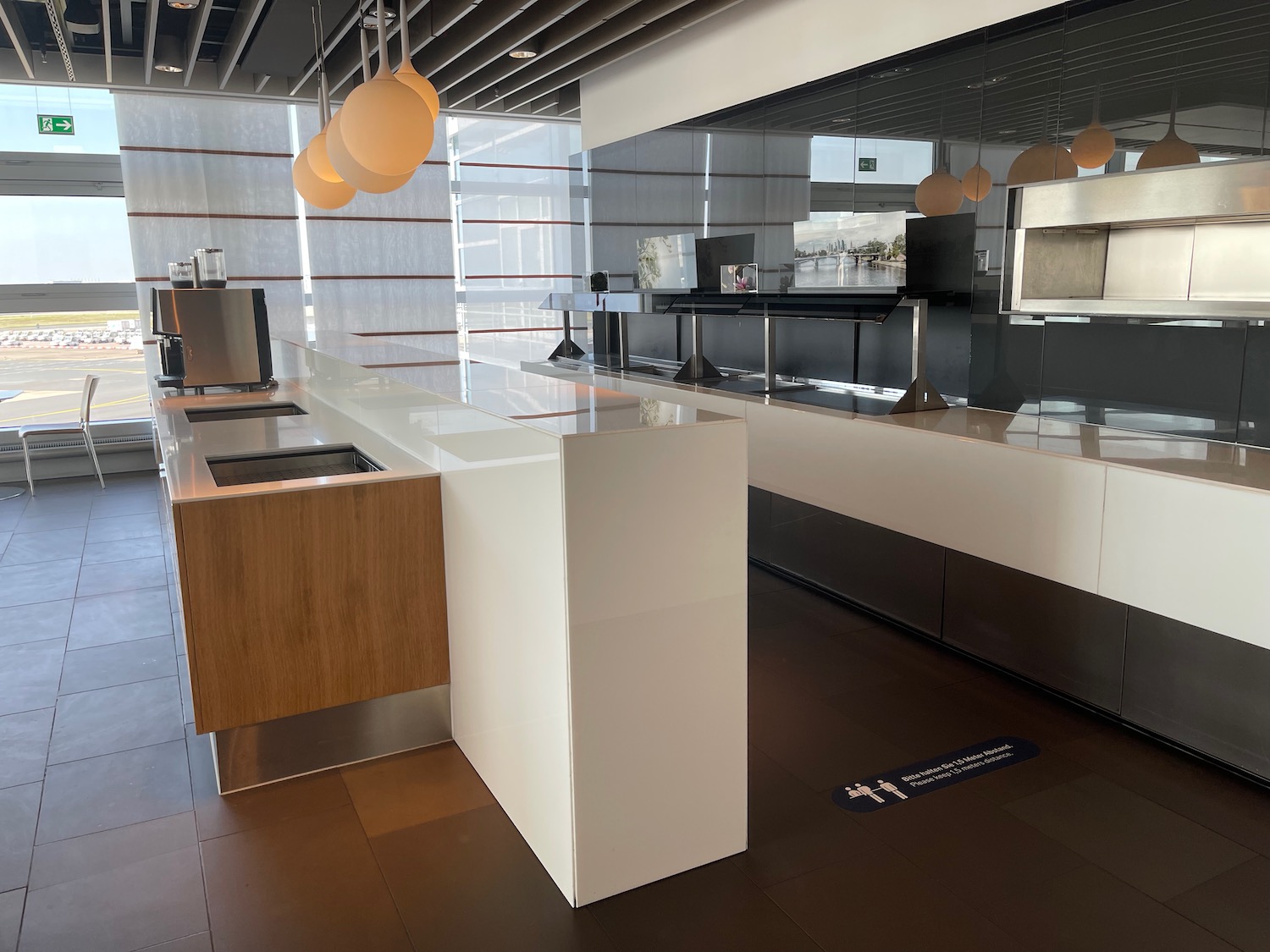 a kitchen with white counter tops and wooden cabinets