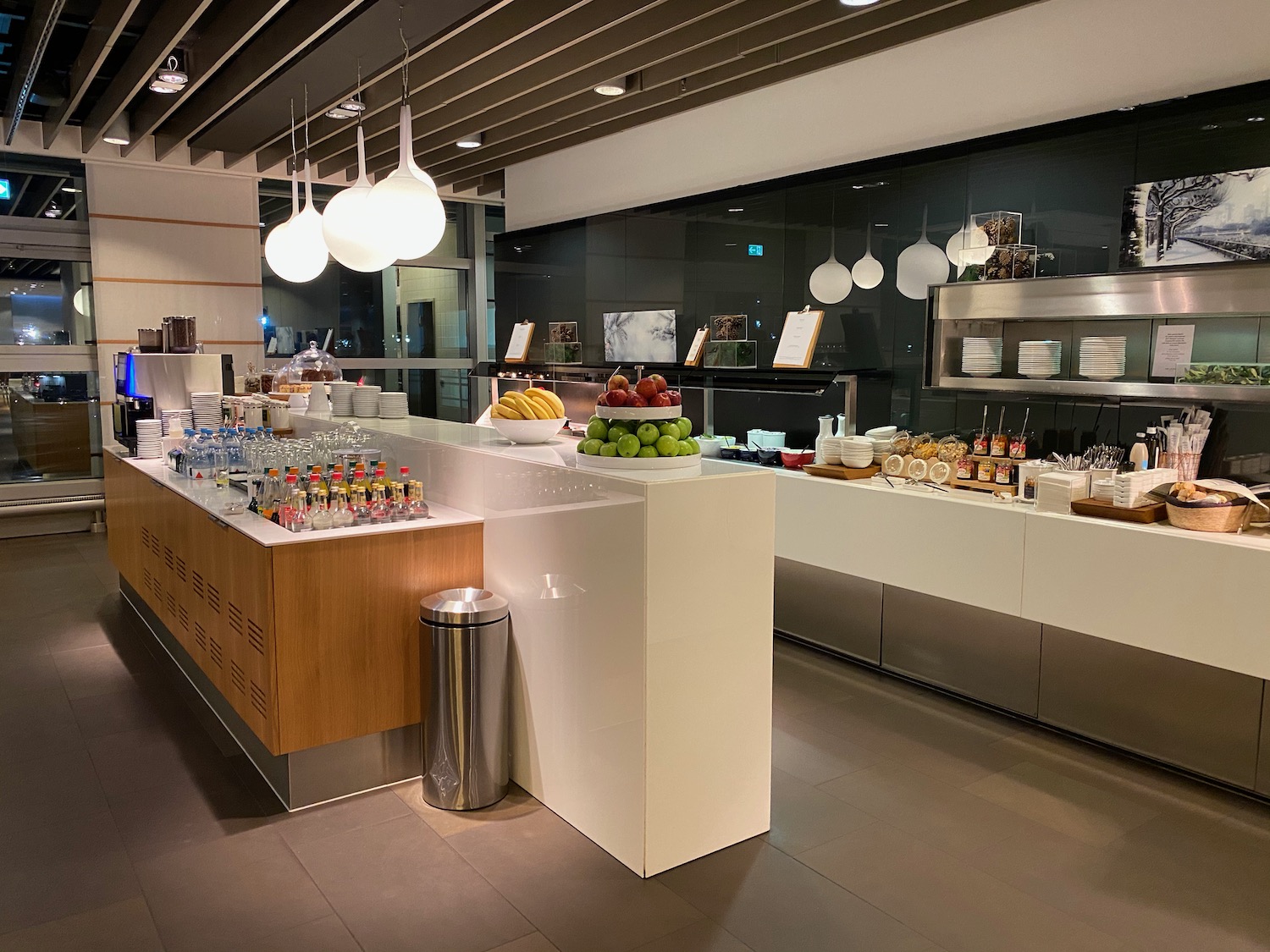 a buffet with fruit and drinks on the counter