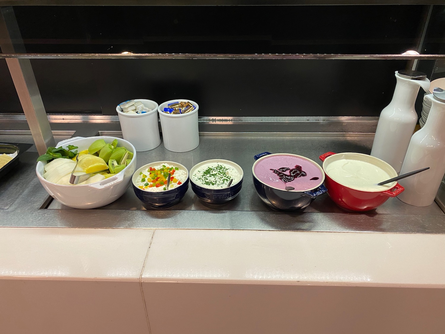 a group of bowls of food on a counter