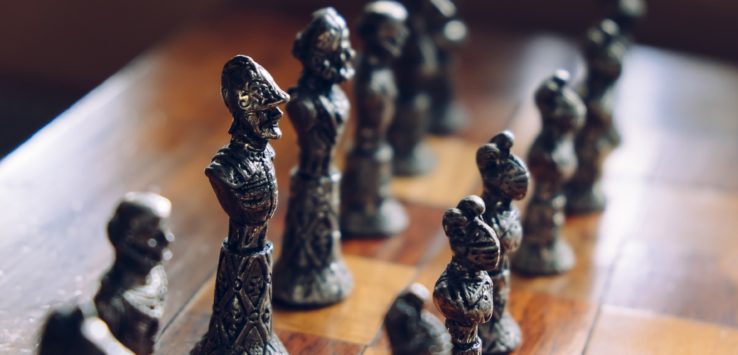 a chess board with metal figures