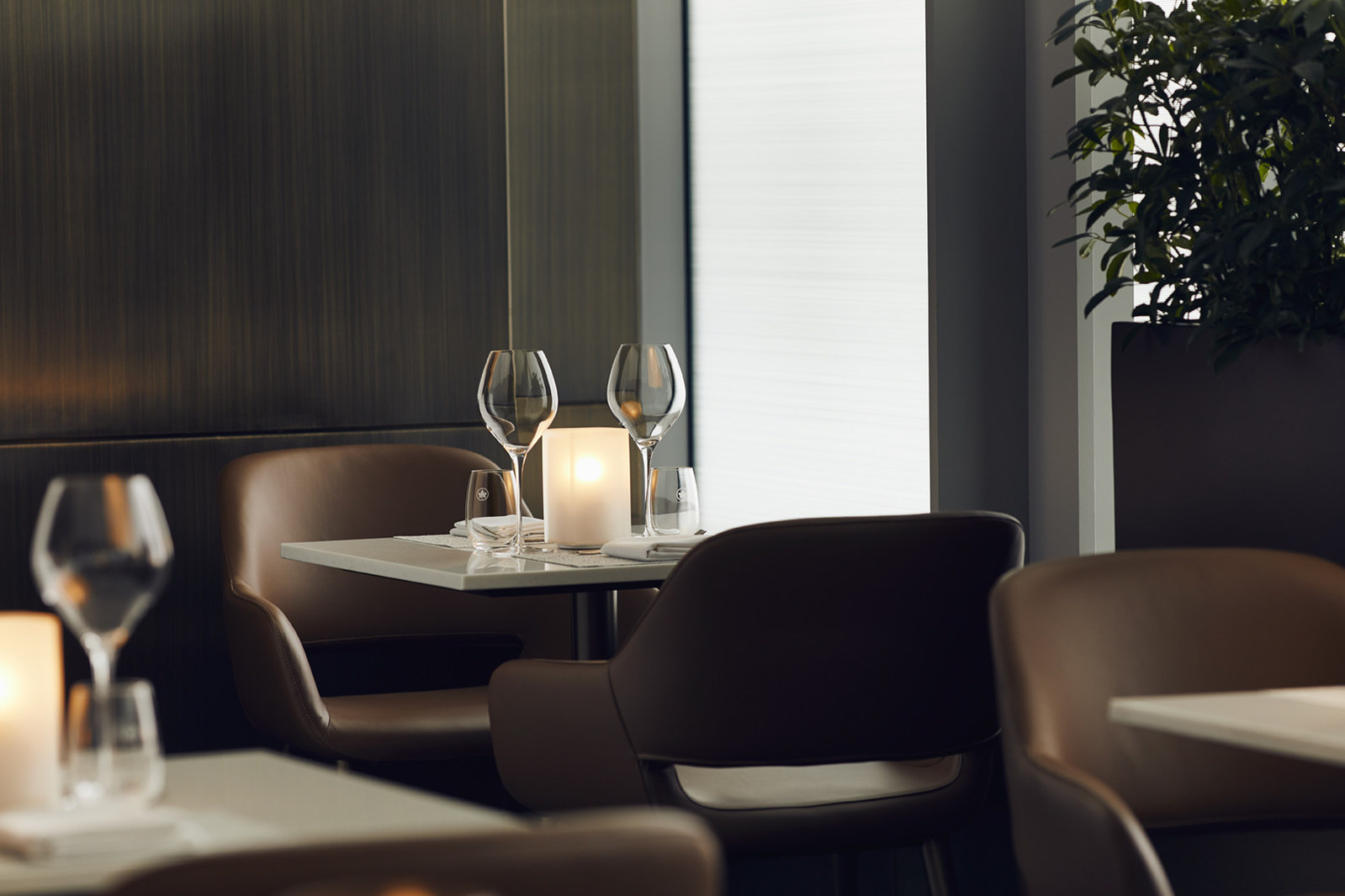 a table with wine glasses and candles on it