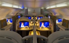a row of seats with monitors on the side