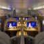 a row of seats with monitors on the side