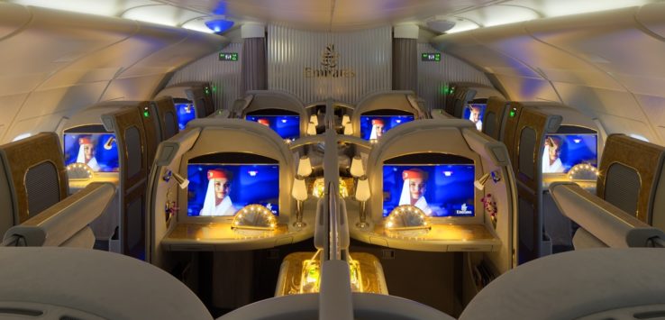 a row of seats with monitors on the side