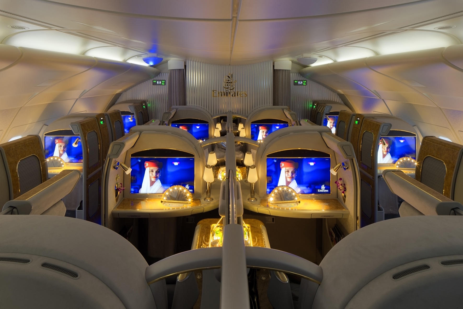 a row of seats with monitors on the side