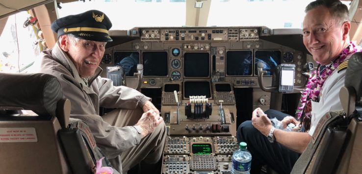 two men sitting in a cockpit of an airplane