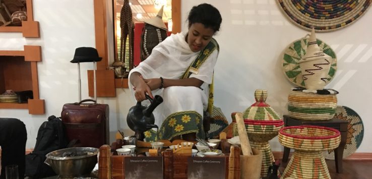 a woman pouring tea into a kettle