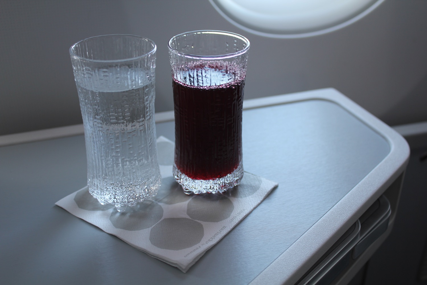 a pair of glasses with liquid on a table