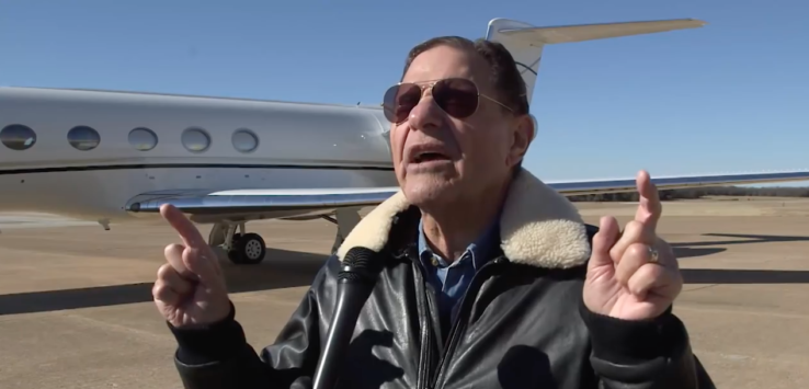 a man in sunglasses speaking into a microphone