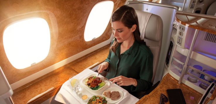 a woman eating food on a plane