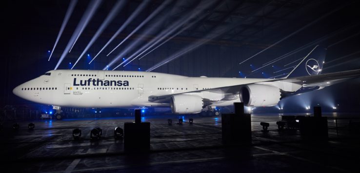 a large white airplane in a hangar