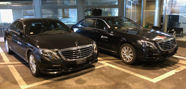 a group of black cars in a parking lot