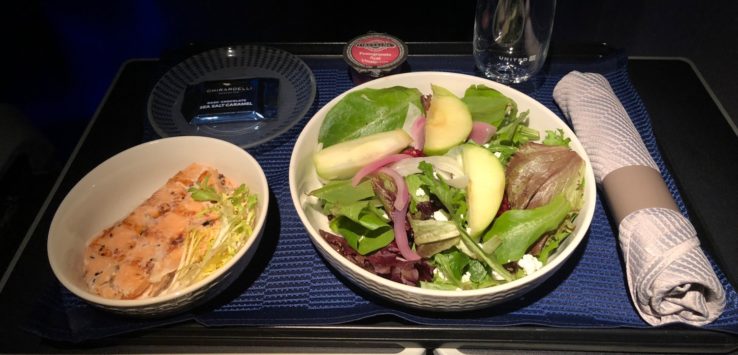 a bowl of salad and a glass of water