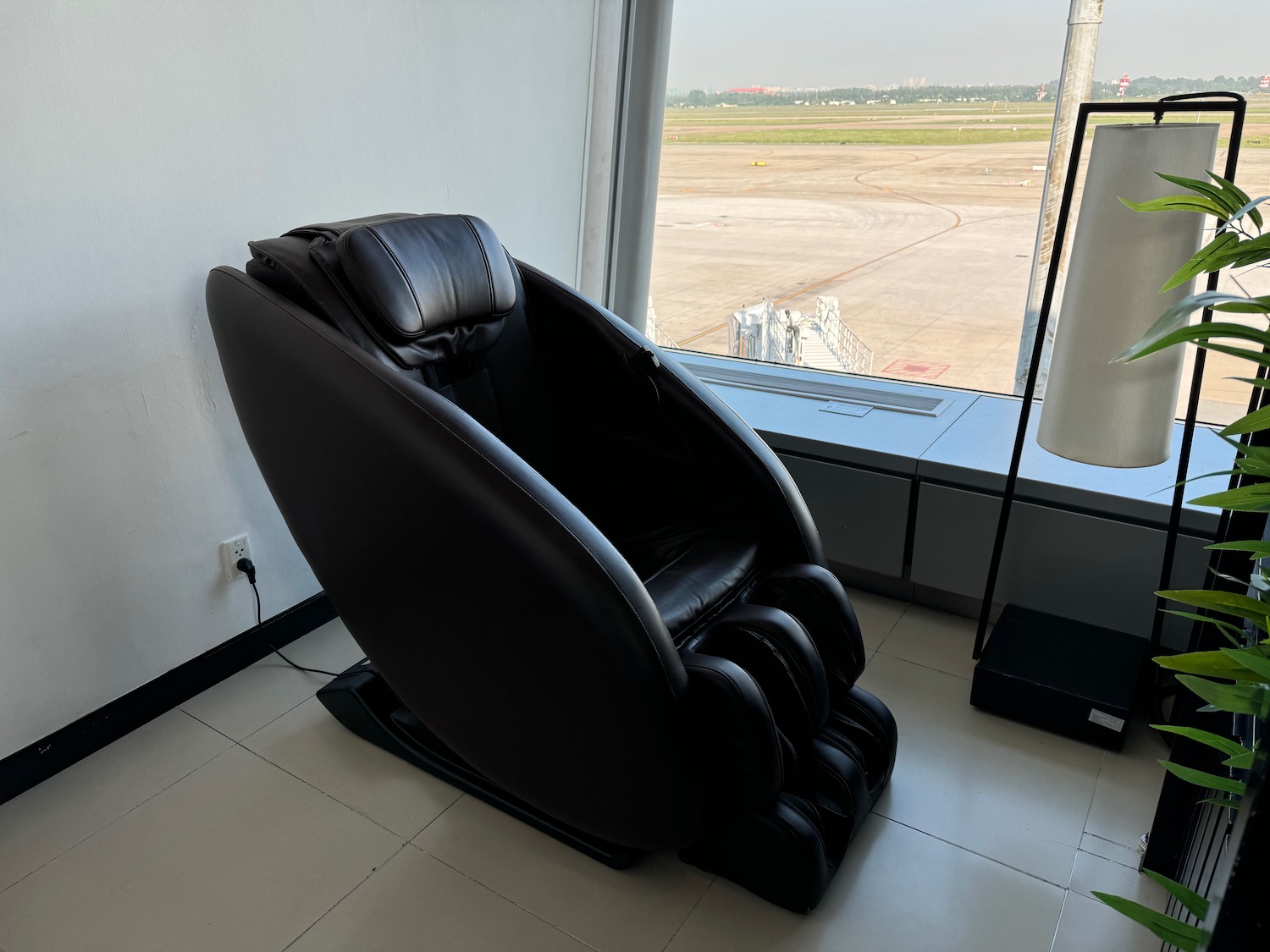 a black massage chair in a room with a window