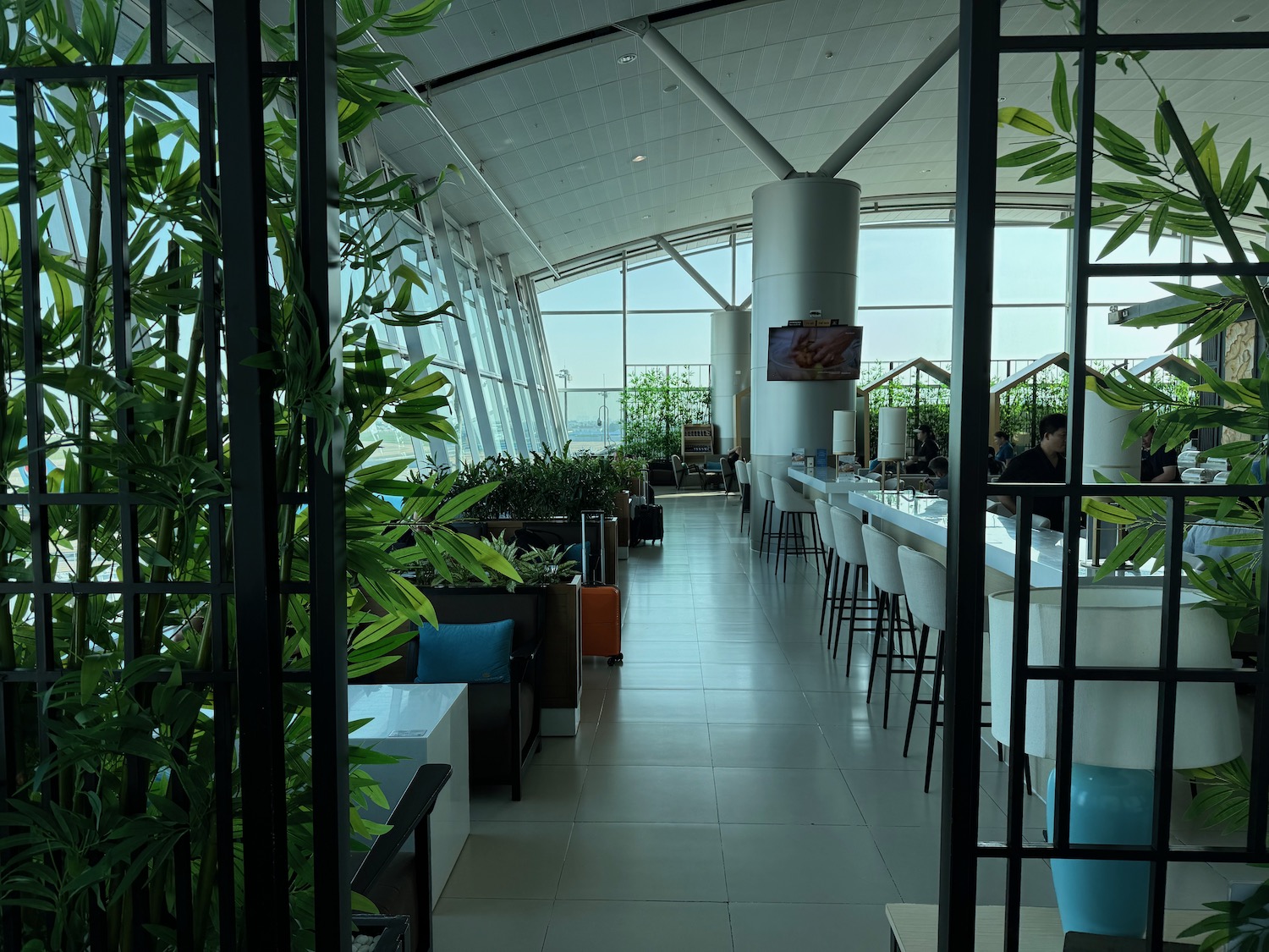 a room with a large window and plants