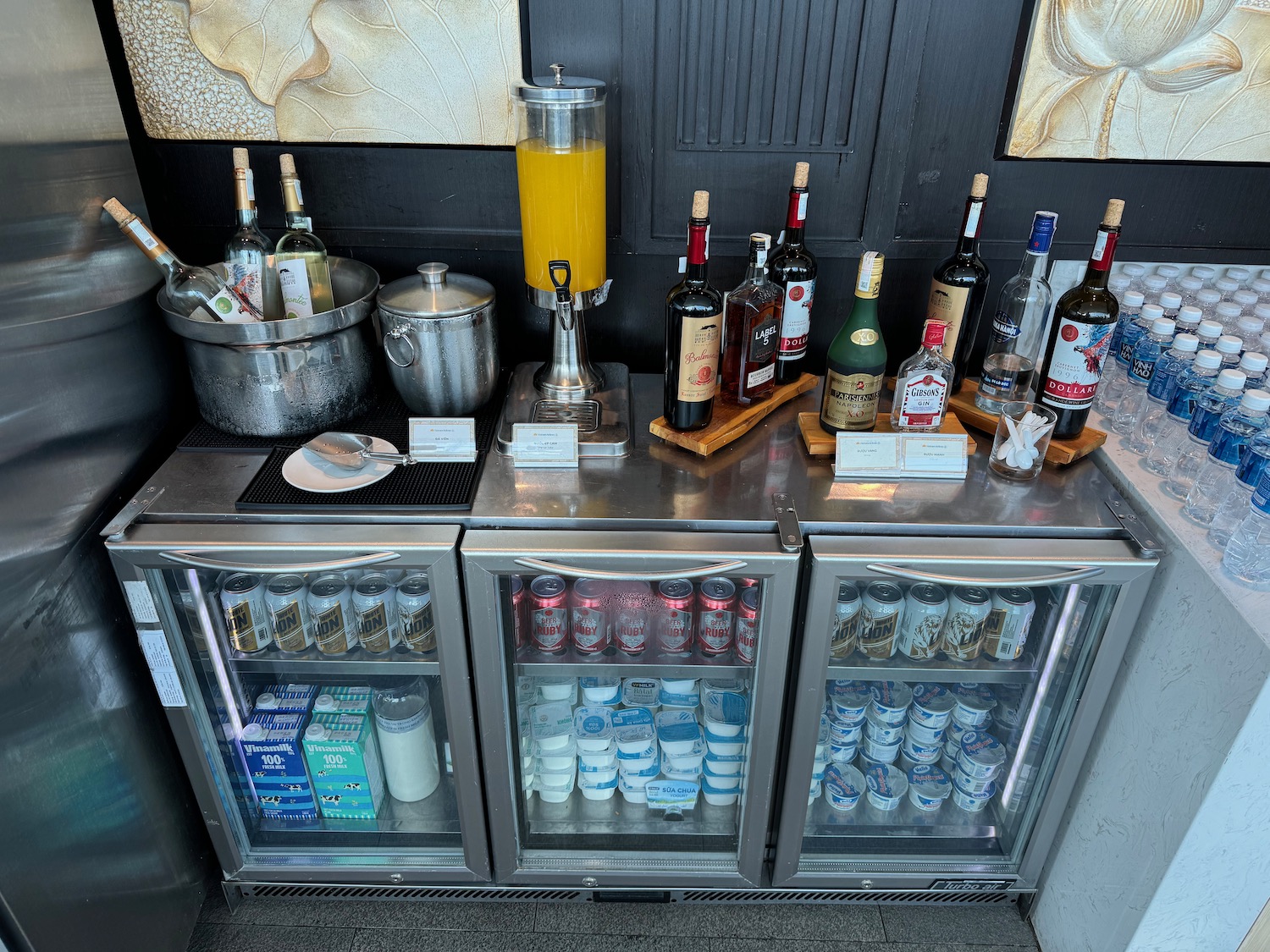 a fridge with drinks and bottles on it