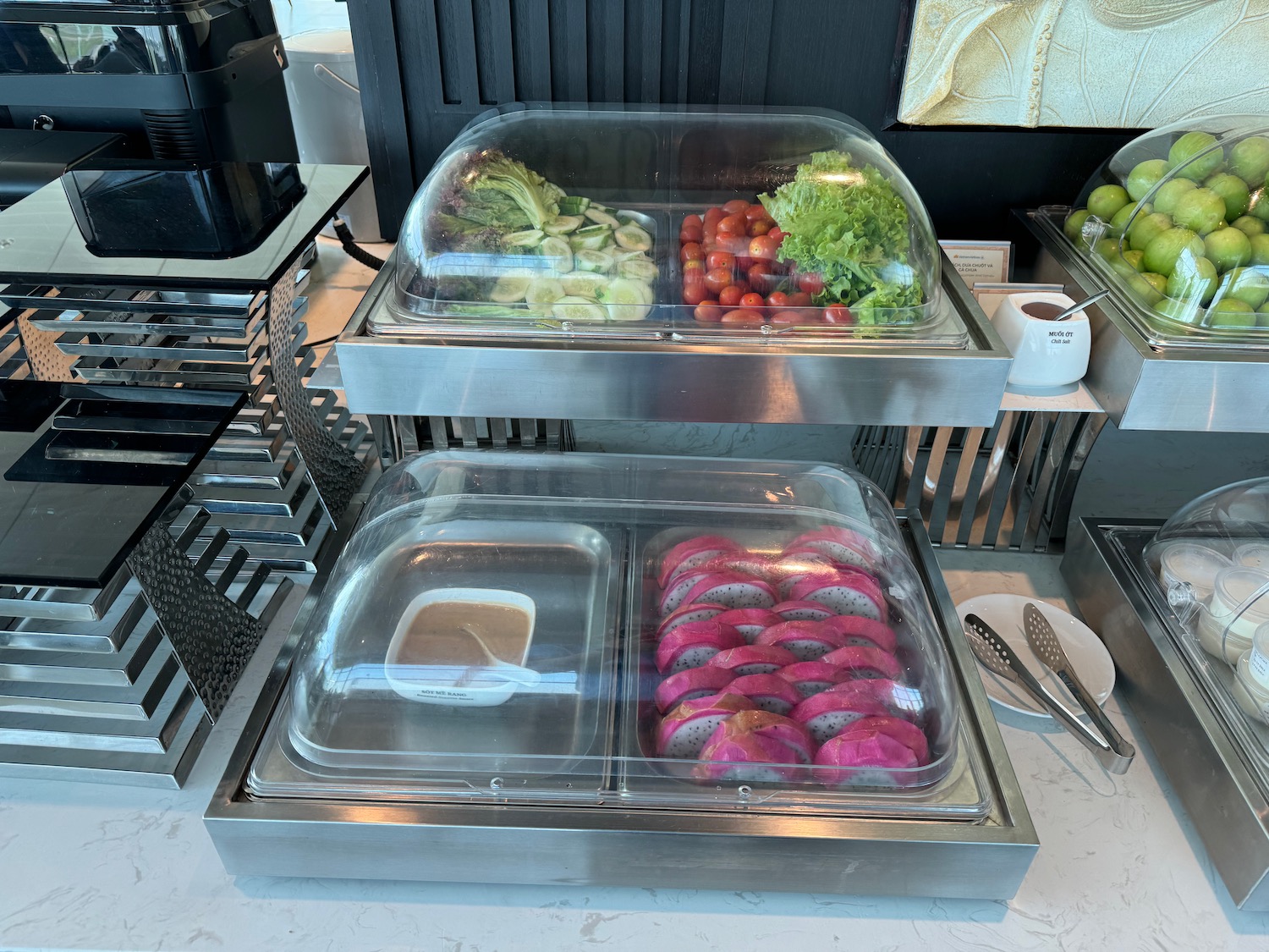 food in a buffet with a tray of vegetables