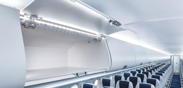 an airplane with an open shelf with blue and white seats