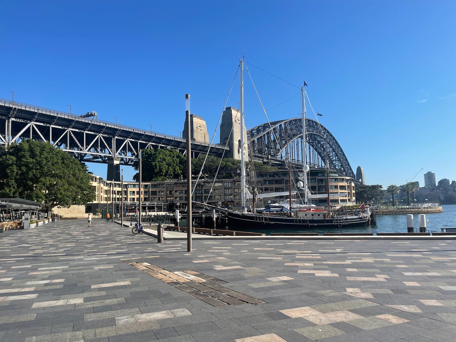 a bridge over water with a boat in the background