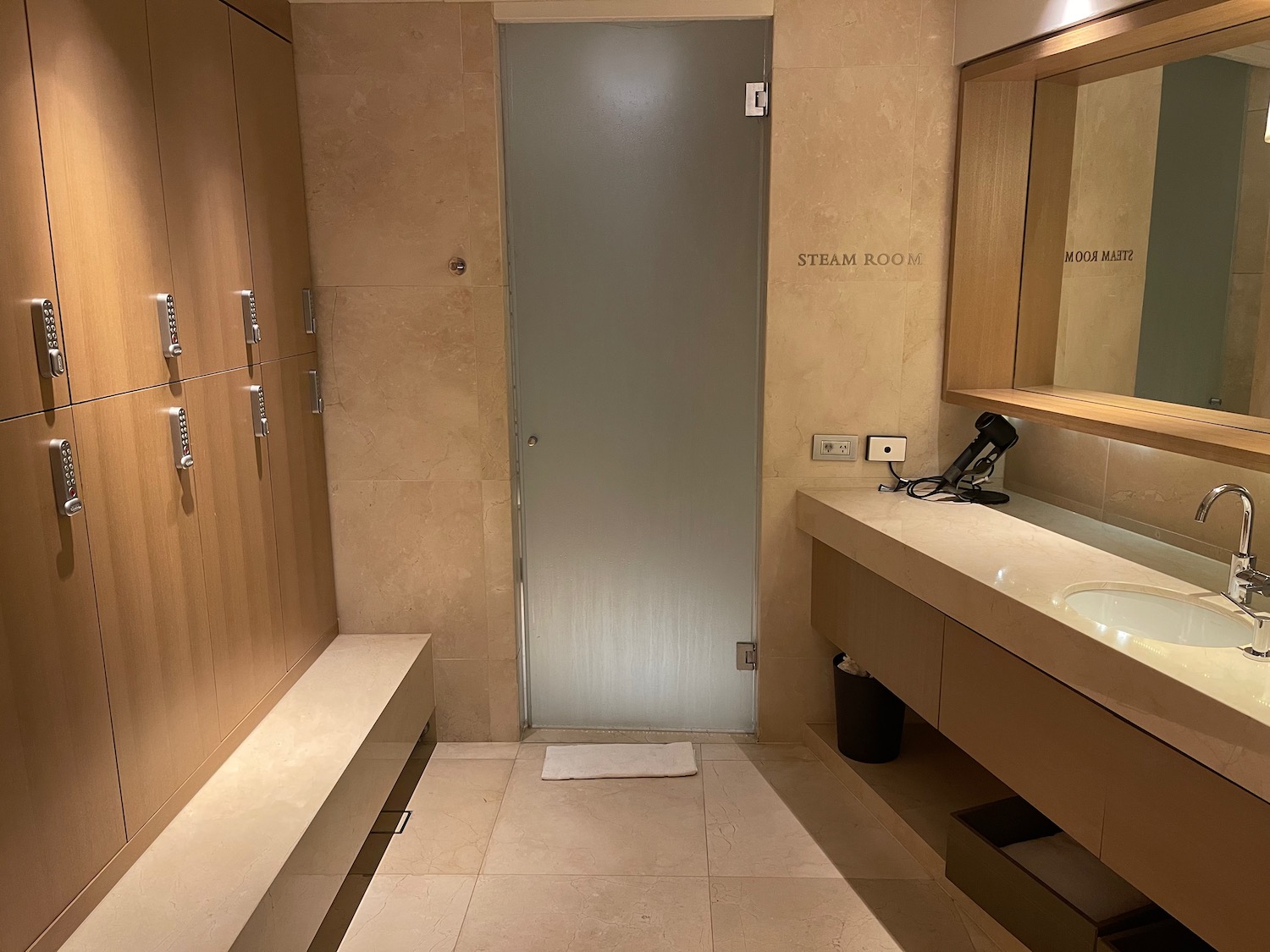 a bathroom with a sink and a glass door