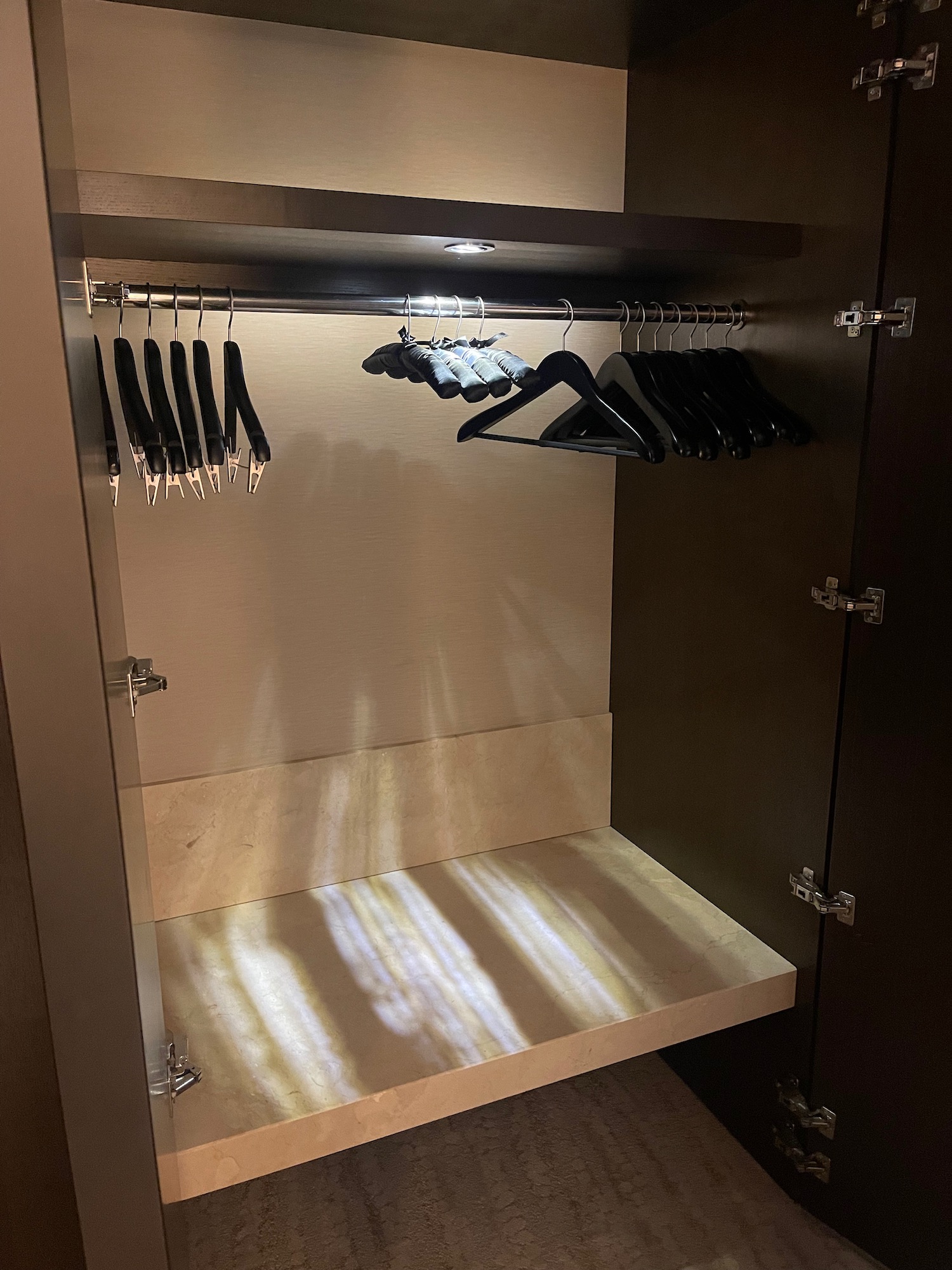 a closet with swingers and a shelf