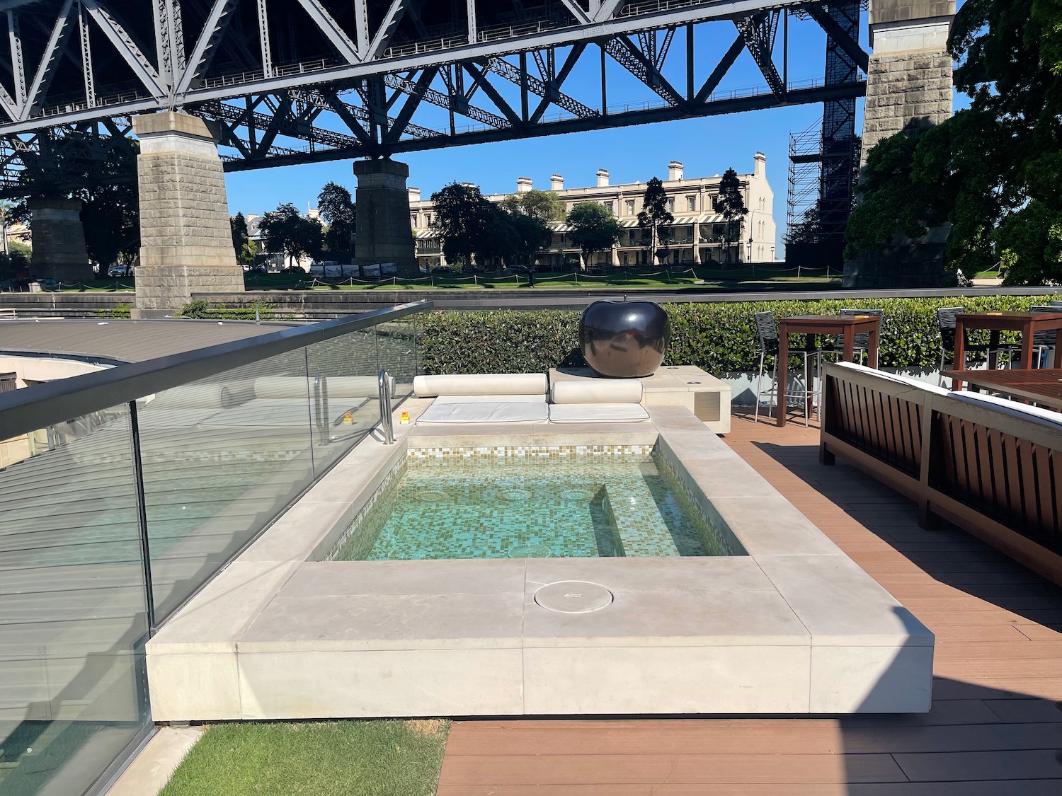 a hot tub with a bridge in the background