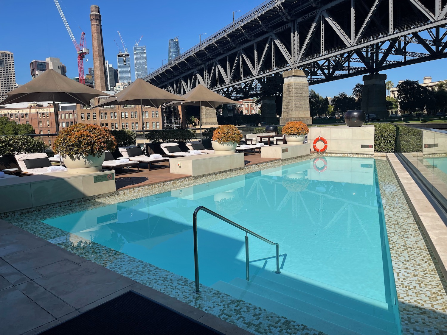 a swimming pool with a bridge in the background