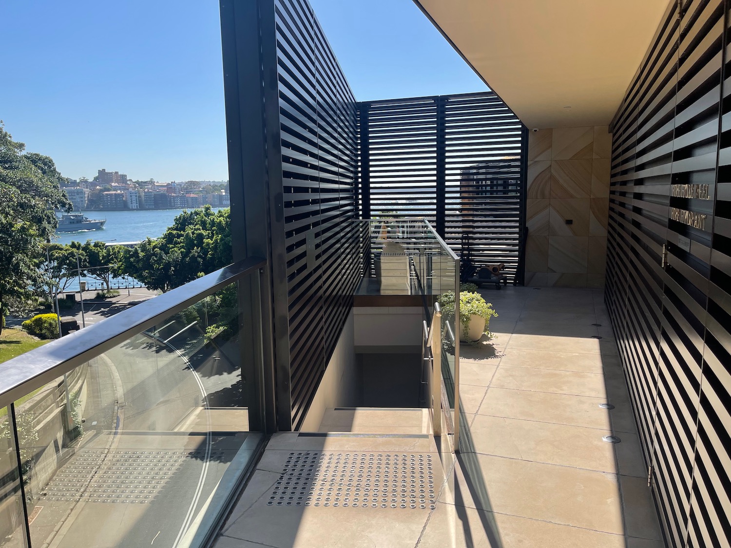 a balcony with a railing and a city in the background