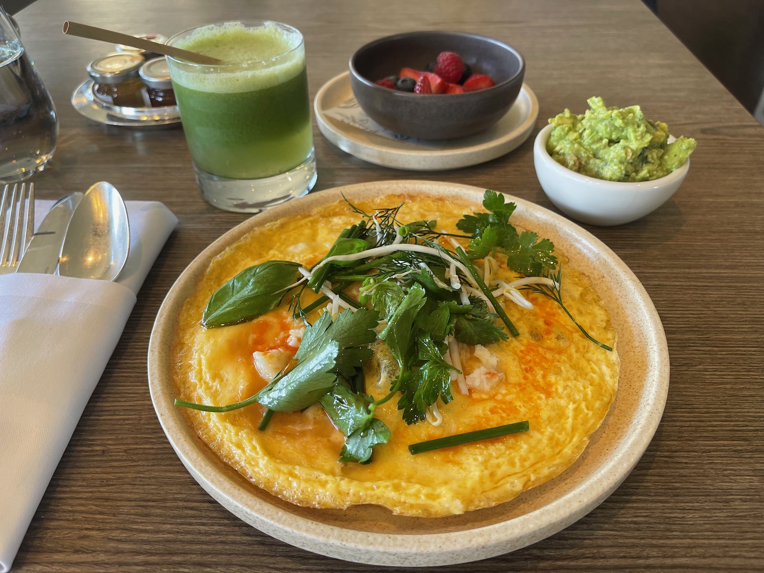 a plate of food with a drink and spoon