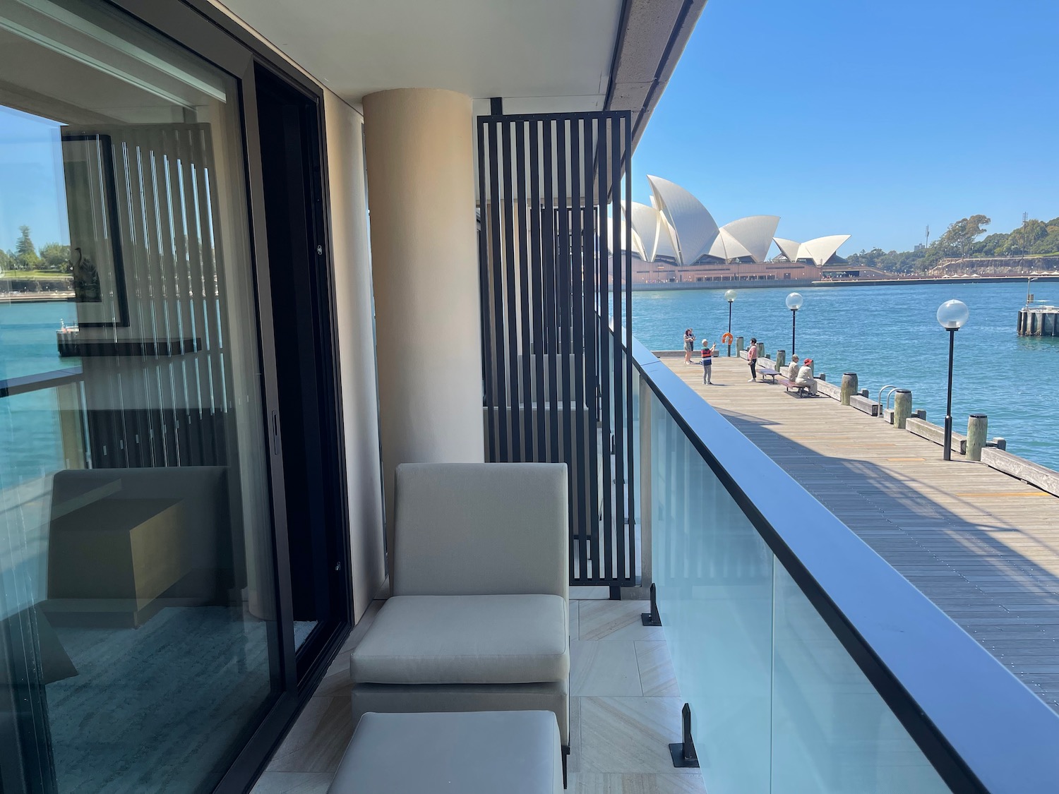 a balcony with chairs and a view of the ocean