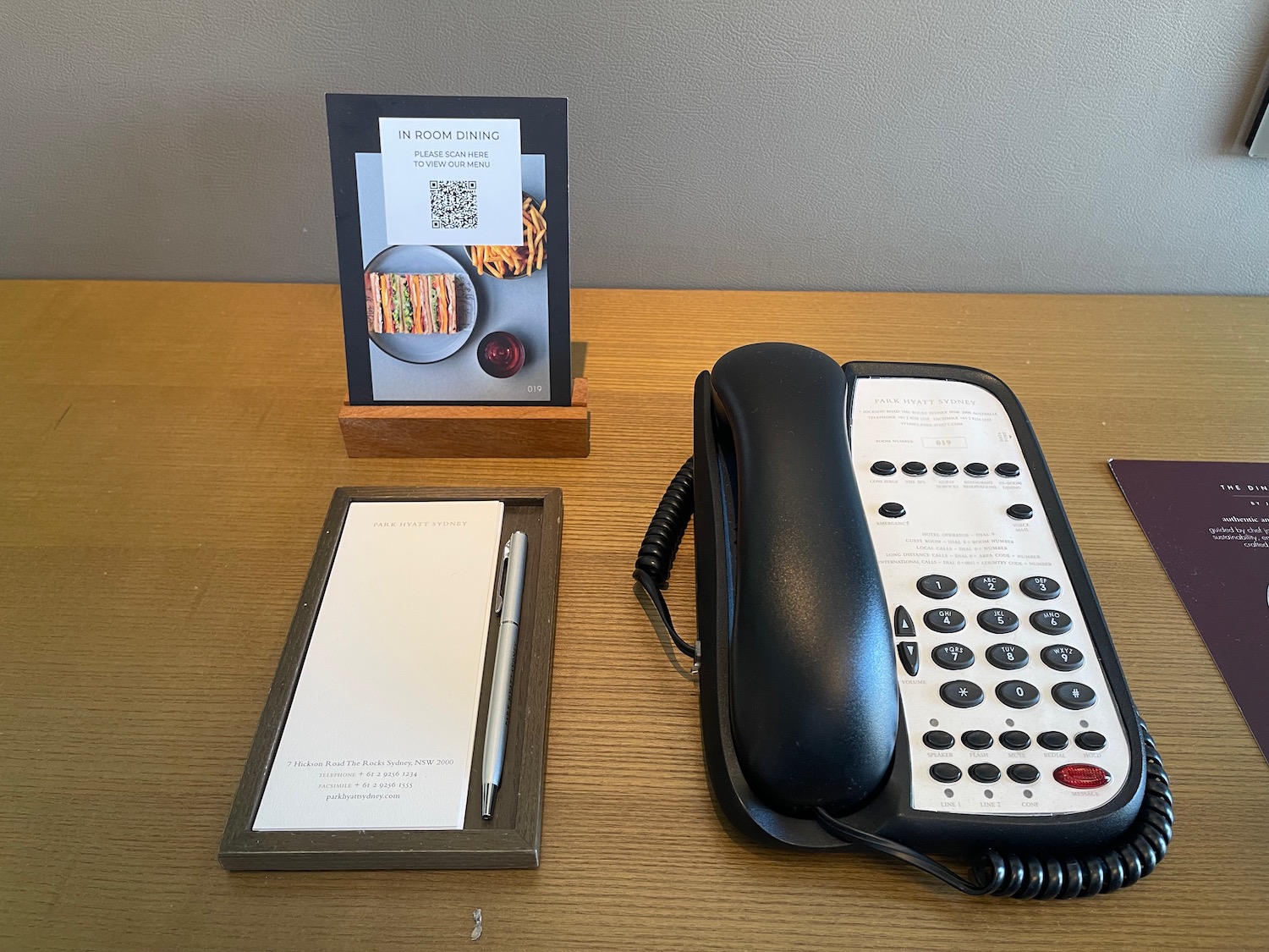 a telephone and note pad on a table