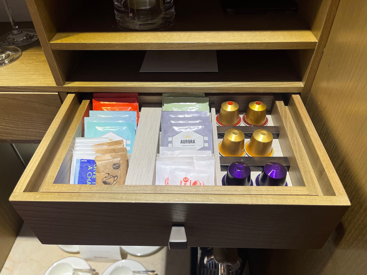 a drawer with coffee capsules and coffee pods