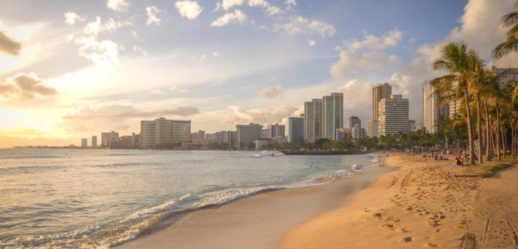 a beach with buildings in the background