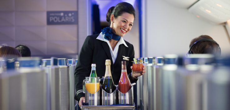 a woman holding a tray of drinks