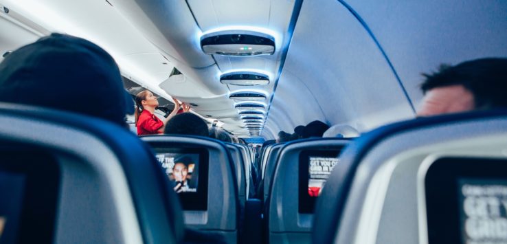 a woman standing in an airplane