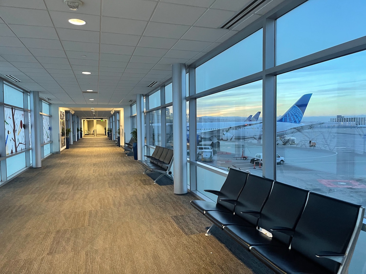 a long hallway with seats and windows