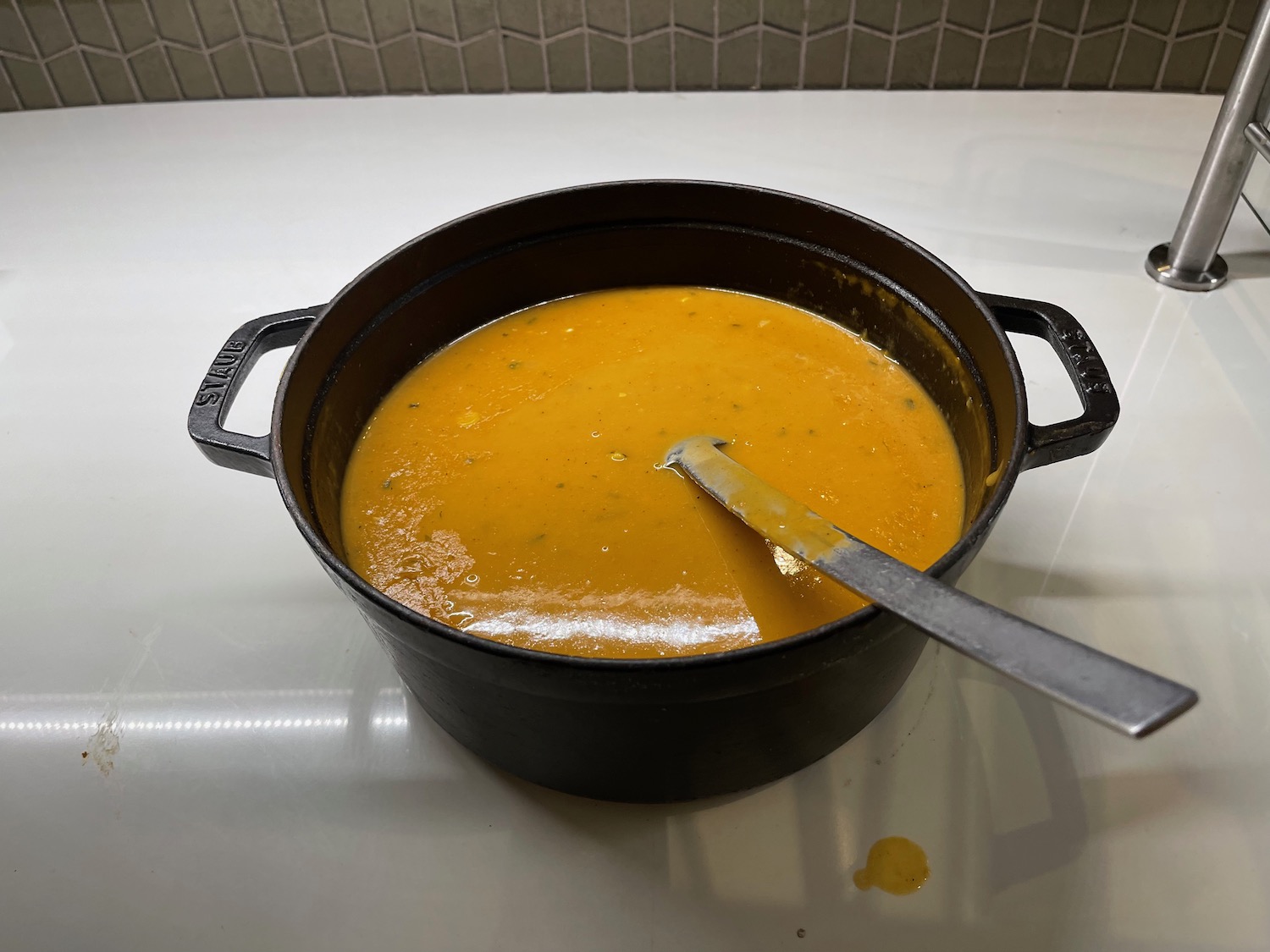 a pot of soup with a spoon