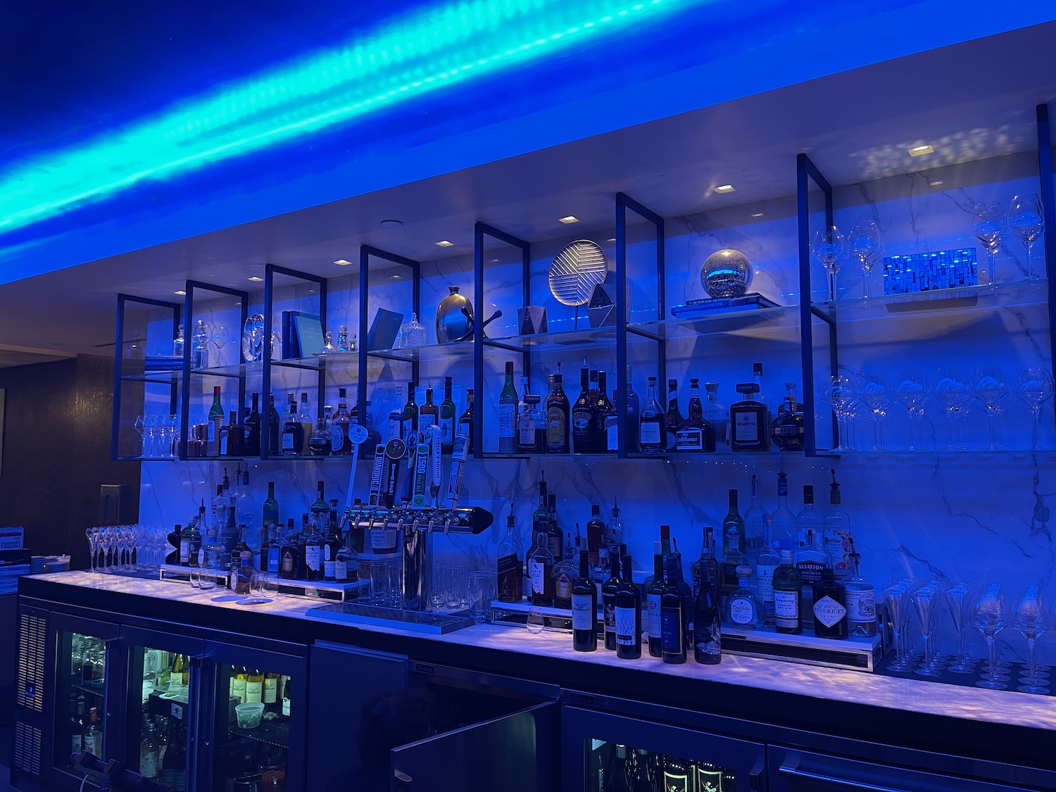 a bar with many bottles and glasses