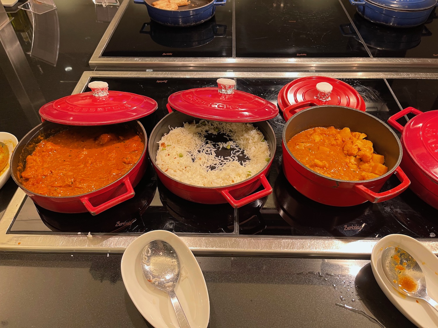 a group of pots with food on a stove